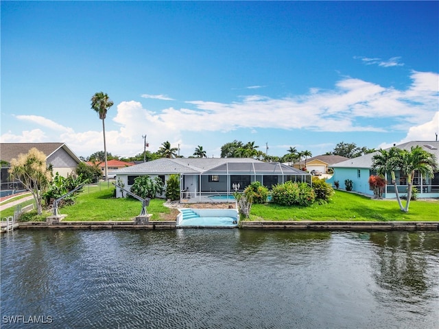 125 SE 41st Ter, Cape Coral, FL 33904 - rear view of house with a water view, a lanai, and a lawn