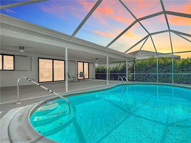 125 SE 41st Ter, Cape Coral, FL 33904 - pool at dusk with a patio area, an outdoor pool, and a lanai