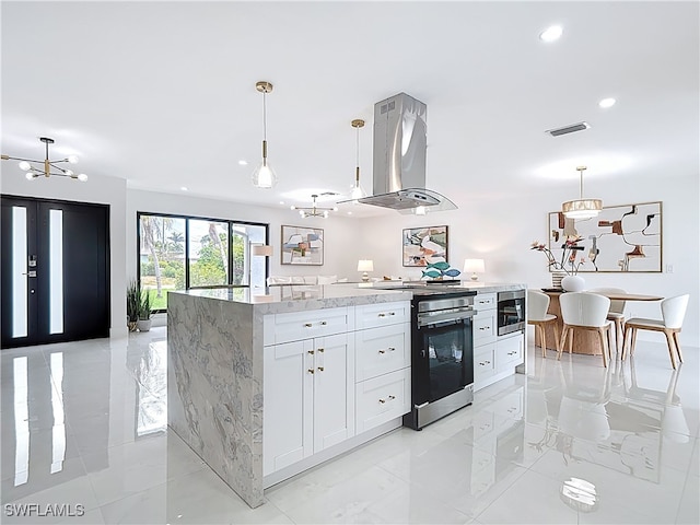 125 SE 41st Ter, Cape Coral, FL 33904 - kitchen featuring island exhaust hood, electric range, white cabinets, light stone countertops, and decorative light fixtures