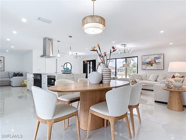 125 SE 41st Ter, Cape Coral, FL 33904 - dining area featuring a chandelier and recessed lighting