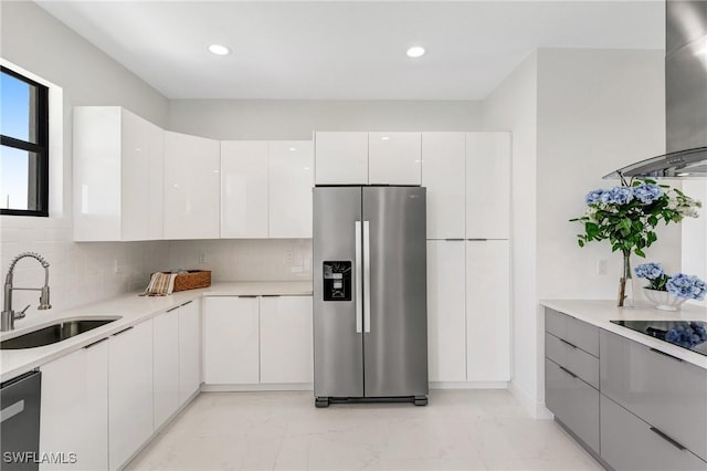 9018 W Castle Cir, Labelle, FL 33935 - kitchen with stainless steel fridge, a sink, wall chimney exhaust hood, dishwashing machine, and modern cabinets