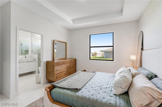 9018 W Castle Cir, Labelle, FL 33935 - bedroom featuring a sink, a raised ceiling, and ensuite bath