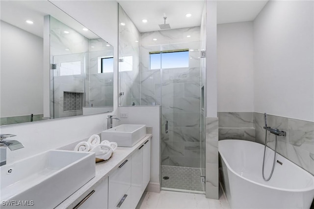 9018 W Castle Cir, Labelle, FL 33935 - full bath with marble look tile flooring, a marble finish shower, a soaking tub, recessed lighting, and double vanity