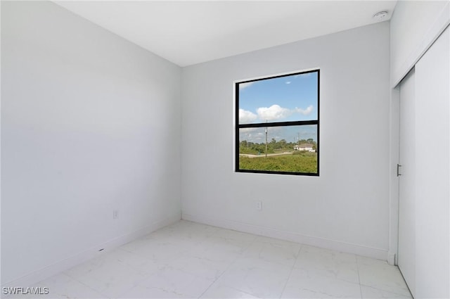 9018 W Castle Cir, Labelle, FL 33935 - unfurnished room with light marble finish flooring, baseboards, and a smoke detector