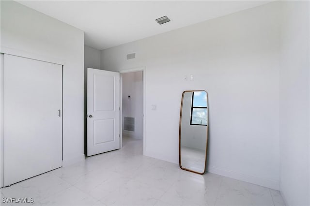 9018 W Castle Cir, Labelle, FL 33935 - unfurnished bedroom with light marble finish floors and baseboards