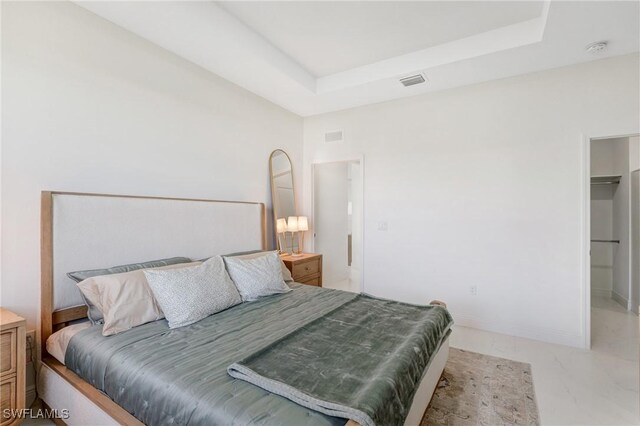 9016 E Justice Cir, Labelle, FL 33935 - bedroom featuring light marble finish flooring, a raised ceiling, and baseboards