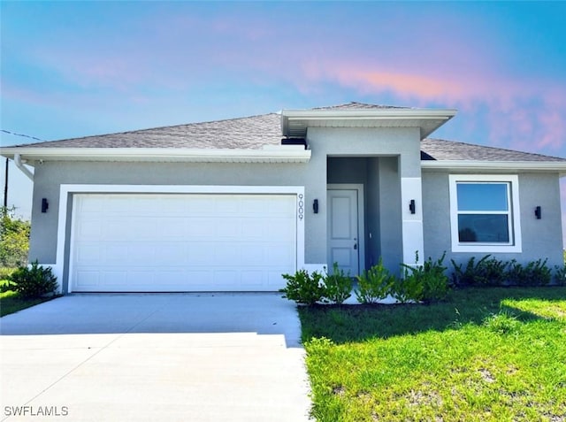 9009 N Indio Cir, Labelle, FL 33935 - ranch-style home featuring concrete driveway, stucco siding, an attached garage, a yard, and roof with shingles