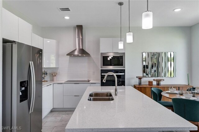 9009 N Indio Cir, Labelle, FL 33935 - kitchen featuring stainless steel fridge, wall oven, wall chimney exhaust hood, modern cabinets, and recessed lighting