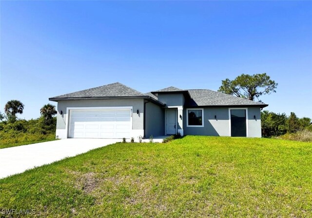 8106 Olive Ct, Labelle, FL 33935 - view of front of property with a garage, stucco siding, a front yard, and concrete driveway
