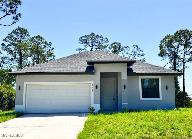 6005 Kumquat Cir, Labelle, FL 33935 - view of front of house with a shingled roof, concrete driveway, a garage, and stucco siding
