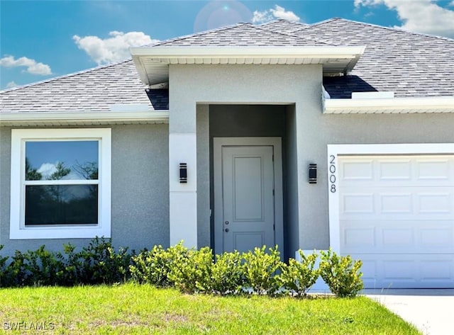 2008 Hercules Rd, Labelle, FL 33935 - property entrance with a shingled roof, an attached garage, and stucco siding