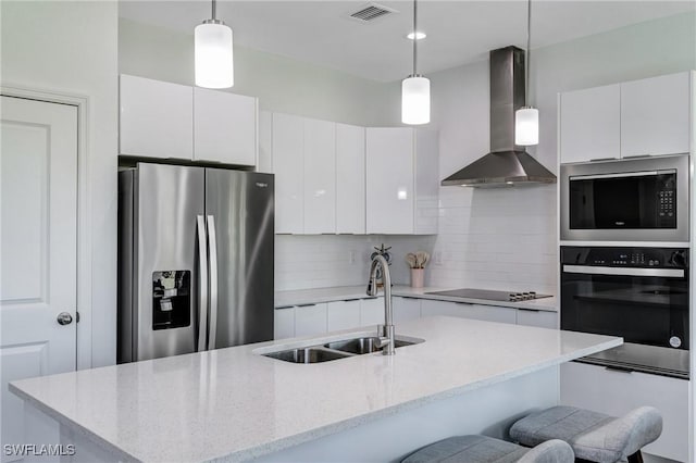 2008 Hercules Rd, Labelle, FL 33935 - kitchen with stainless steel fridge, wall oven, wall chimney range hood, a sink, and built in microwave