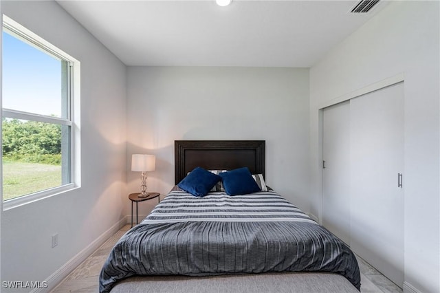 2008 Hercules Rd, Labelle, FL 33935 - bedroom featuring multiple windows, baseboards, and a closet