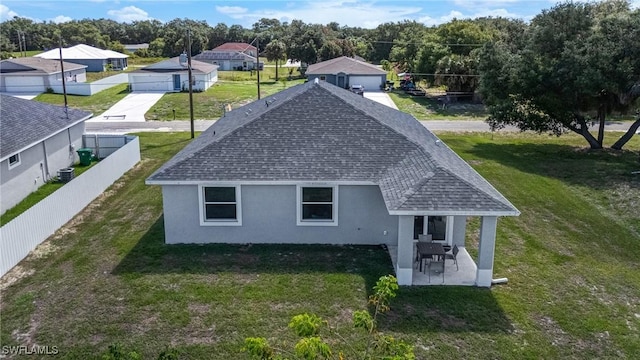 2013 Inglewood Cir, Labelle, FL 33935 - back of property featuring roof with shingles, stucco siding, a patio, a detached garage, and a residential view