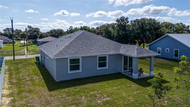 2013 Inglewood Cir, Labelle, FL 33935 - rear view of house with stucco siding, a yard, a shingled roof, a patio area, and central AC unit