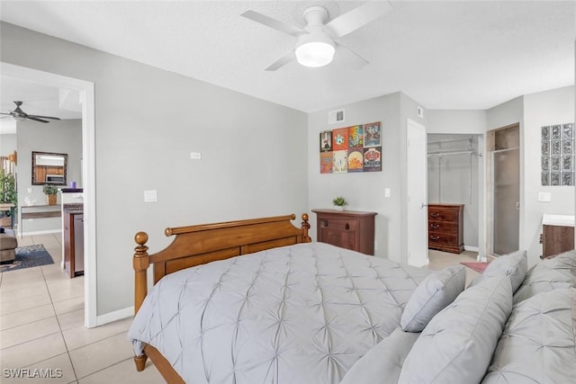 12520 Equestrian Cir Unit 310, Fort Myers, FL 33907 - bedroom featuring light tile patterned floors, a closet, ensuite bath, a ceiling fan, and a spacious closet
