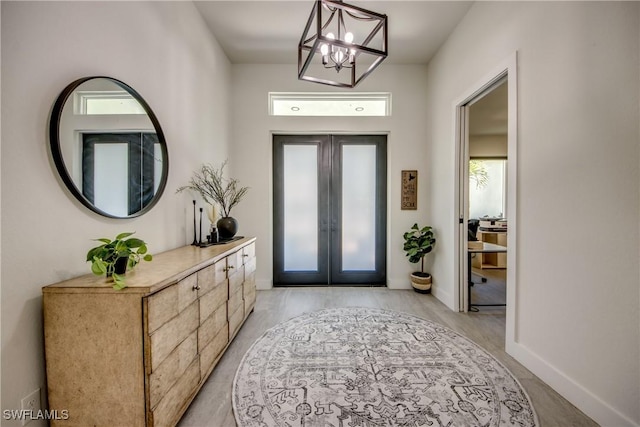 3621 NW 14th St, Cape Coral, FL 33993 - entryway with a chandelier, french doors, healthy amount of natural light, and baseboards
