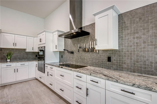 3621 NW 14th St, Cape Coral, FL 33993 - kitchen with wall chimney range hood, black appliances, tasteful backsplash, white cabinetry, and light stone countertops