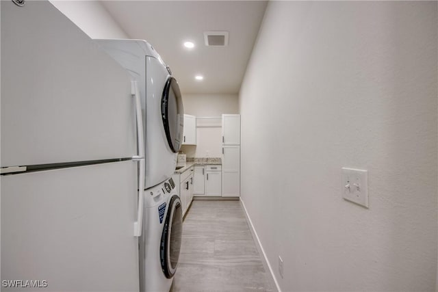 3621 NW 14th St, Cape Coral, FL 33993 - clothes washing area with estacked washer and dryer, baseboards, and recessed lighting
