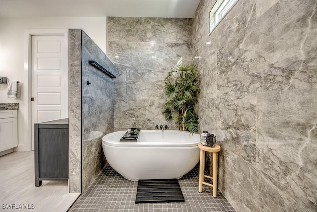 3621 NW 14th St, Cape Coral, FL 33993 - full bath with a freestanding tub, tile walls, tile patterned flooring, and vanity
