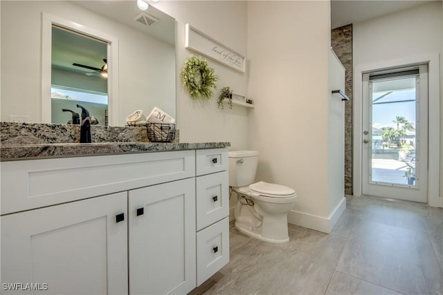 3621 NW 14th St, Cape Coral, FL 33993 - full bath with toilet, baseboards, vanity, tile patterned flooring, and ceiling fan