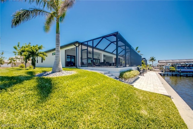 3621 NW 14th St, Cape Coral, FL 33993 - dock area featuring a yard, glass enclosure, and a patio area