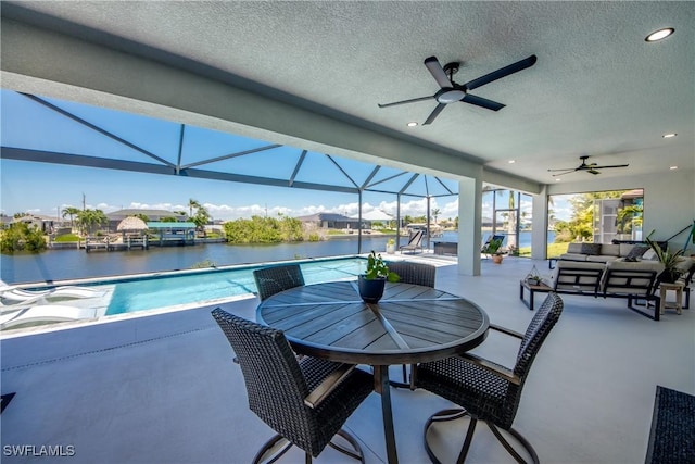 3621 NW 14th St, Cape Coral, FL 33993 - view of patio with outdoor lounge area, a ceiling fan, a water view, and an outdoor pool