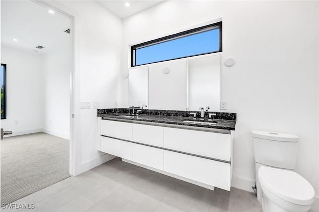 507 107th Ave N, Naples, FL 34108 - full bathroom with double vanity, baseboards, toilet, and recessed lighting
