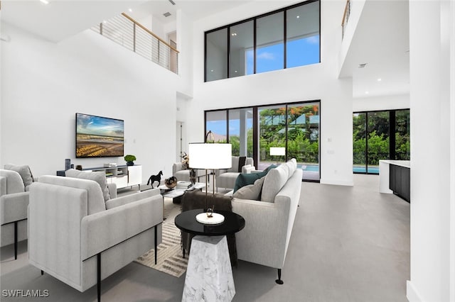 507 107th Ave N, Naples, FL 34108 - living area featuring concrete flooring, a towering ceiling, and recessed lighting