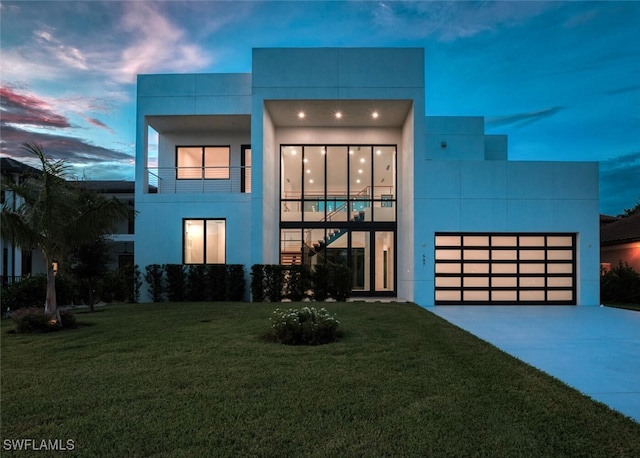 507 107th Ave N, Naples, FL 34108 - modern home with concrete driveway, a front lawn, stucco siding, and a balcony