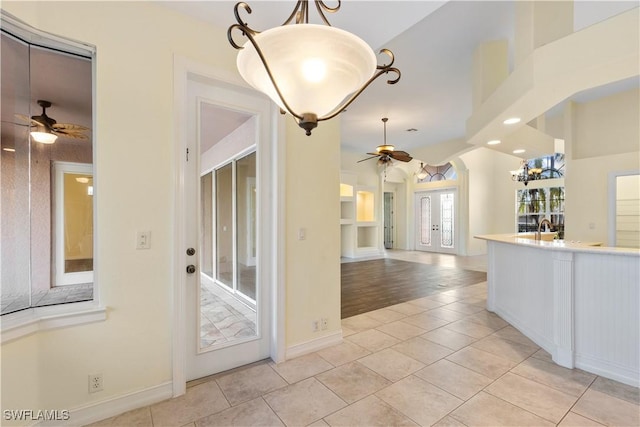 325 SE 21st St, Cape Coral, FL 33990 - kitchen with a ceiling fan, decorative light fixtures, light countertops, baseboards, and a sink