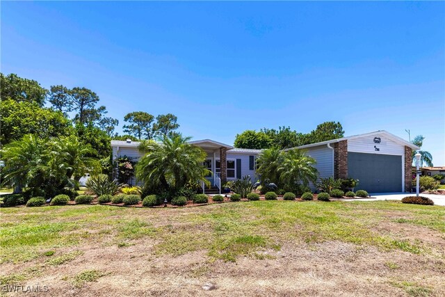 19703 Eagle Trace Ct, North Fort Myers, FL 33903 - view of front facade featuring a front lawn, concrete driveway, brick siding, and a garage