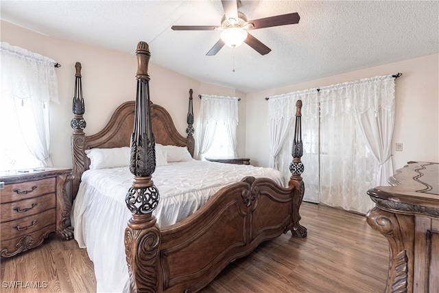 19703 Eagle Trace Ct, North Fort Myers, FL 33903 - bedroom featuring light wood finished floors, a textured ceiling, and ceiling fan