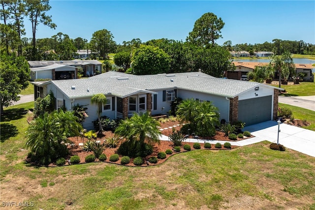 19703 Eagle Trace Ct, North Fort Myers, FL 33903 - ranch-style house featuring concrete driveway, a water view, a front yard, and view of scattered trees