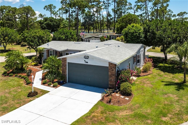 19703 Eagle Trace Ct, North Fort Myers, FL 33903 - view of front of home featuring brick siding, a garage, driveway, and a front lawn