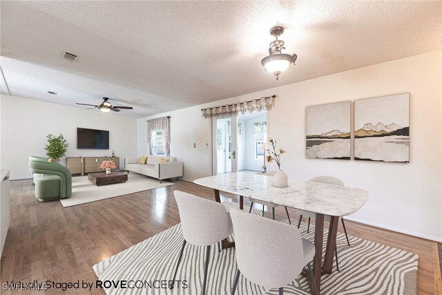 19703 Eagle Trace Ct, North Fort Myers, FL 33903 - dining room featuring a textured ceiling, wood finished floors, and ceiling fan