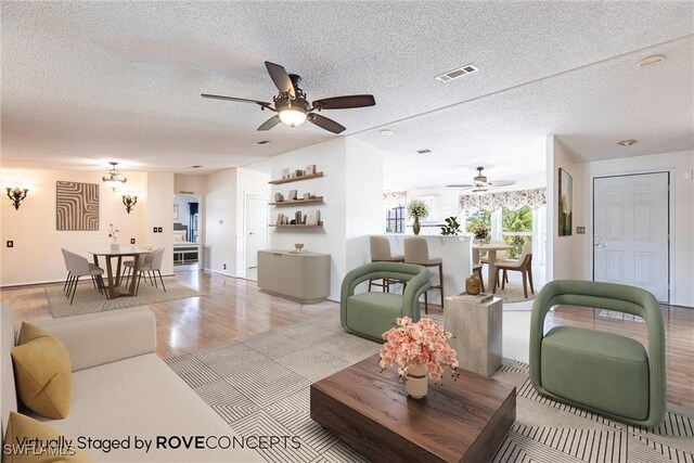 19703 Eagle Trace Ct, North Fort Myers, FL 33903 - living room featuring a ceiling fan and a textured ceiling