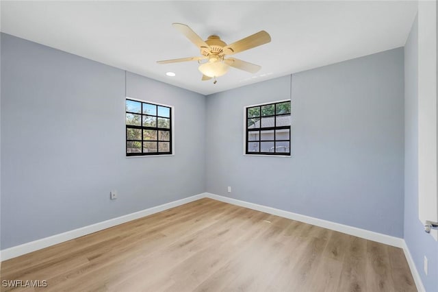 3163 Caledonia Ave, Naples, FL 34112 - empty room featuring healthy amount of natural light, light wood-style floors, and baseboards