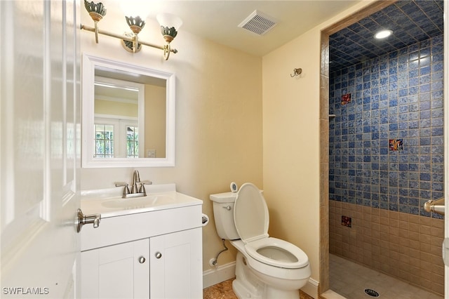5697 Bay Point Rd, Bokeelia, FL 33922 - bathroom with a tile shower, toilet, vanity, and baseboards