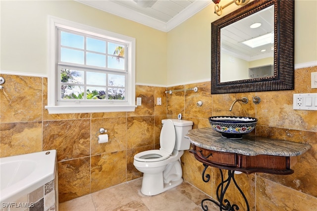 5697 Bay Point Rd, Bokeelia, FL 33922 - bathroom with ornamental molding, tile walls, toilet, a sink, and tiled tub