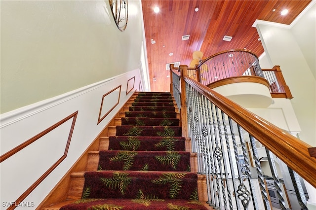 5697 Bay Point Rd, Bokeelia, FL 33922 - stairs with wood ceiling, wainscoting, a decorative wall, recessed lighting, and crown molding