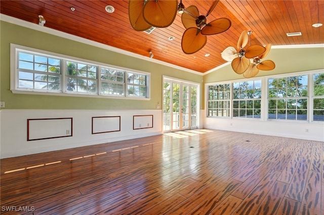 5697 Bay Point Rd, Bokeelia, FL 33922 - spare room featuring healthy amount of natural light, wooden ceiling, wood finished floors, crown molding, and a ceiling fan