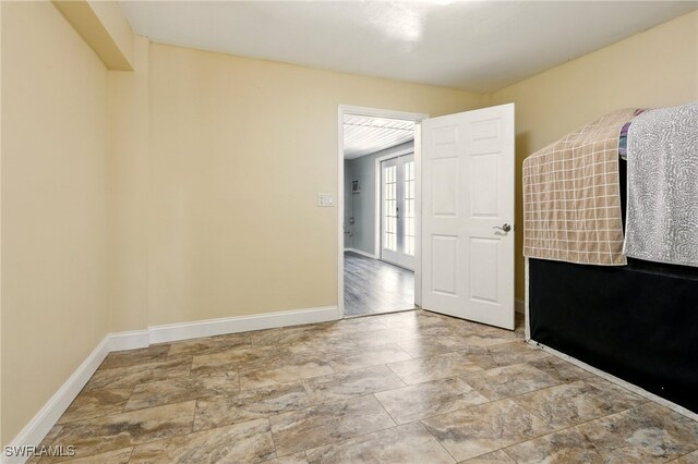 5697 Bay Point Rd, Bokeelia, FL 33922 - unfurnished room featuring baseboards and stone finish flooring