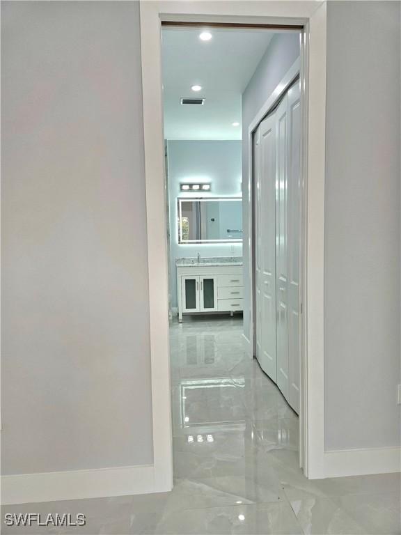 4391 66th Ave NE, Naples, FL 34120 - hall with baseboards and marble tiled floors