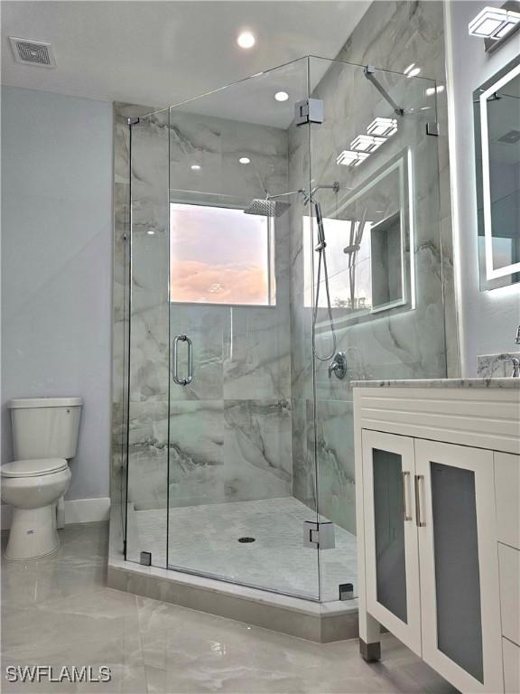 4391 66th Ave NE, Naples, FL 34120 - bathroom featuring toilet, vanity, a stall shower, baseboards, and recessed lighting