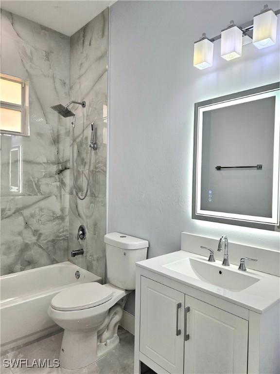 4391 66th Ave NE, Naples, FL 34120 - full bathroom with vanity, toilet, and  shower combination