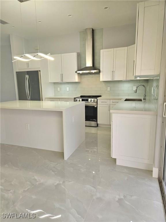 4391 66th Ave NE, Naples, FL 34120 - kitchen featuring wall chimney exhaust hood, appliances with stainless steel finishes, a sink, light marble finish floors, and backsplash