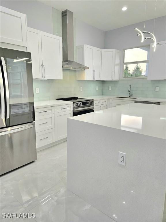 4391 66th Ave NE, Naples, FL 34120 - kitchen featuring appliances with stainless steel finishes, wall chimney exhaust hood, a sink, light countertops, and decorative backsplash