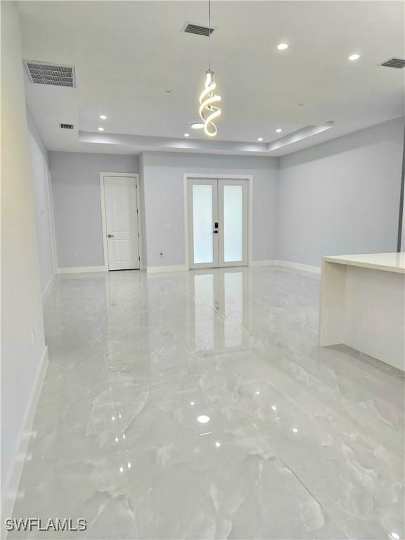 4391 66th Ave NE, Naples, FL 34120 - empty room featuring a tray ceiling, baseboards, marble tiled flooring, recessed lighting, and french doors
