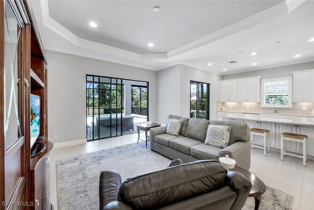 8396 Promoso Ct, Naples, FL 34114 - living room featuring light tile patterned flooring, a tray ceiling, recessed lighting, and crown molding
